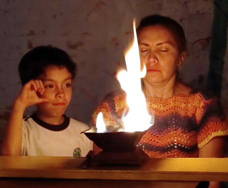 Magnolia Castrillon Vanegas and her son performing Agnihotra